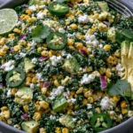 Mexican Street Corn Kale Salad with jalapeños, avocado, cotija cheese, and grilled corn in a bowl