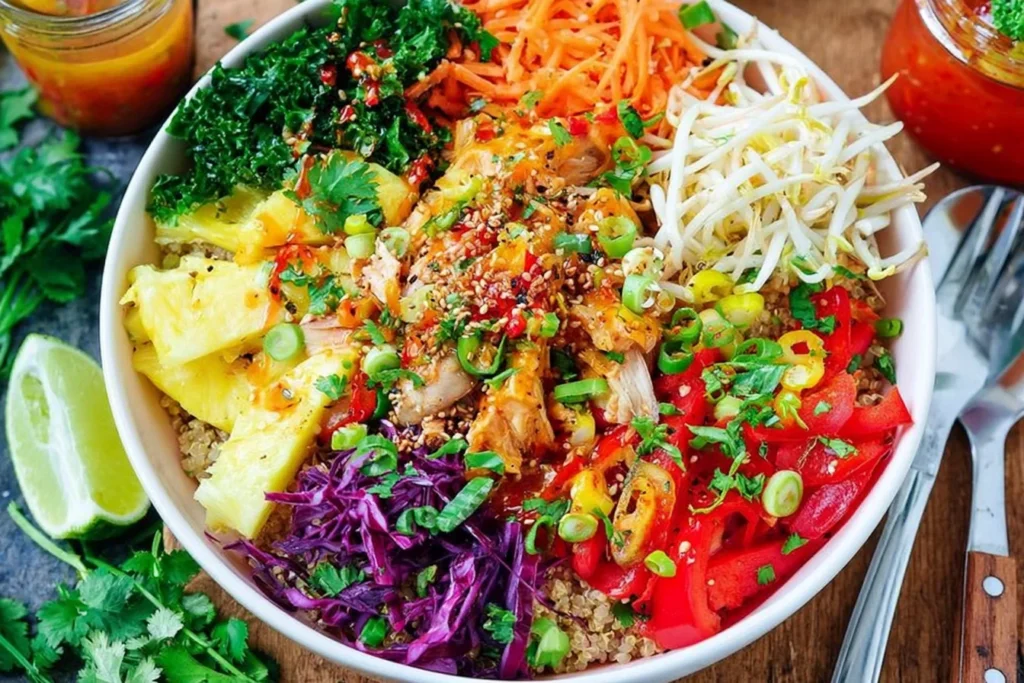 Thai Sweet Chili Chicken Buddha Bowls with quinoa, pineapple, kale, crunchy veggies, and sweet chili sauce drizzle