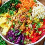 Thai Sweet Chili Chicken Buddha Bowls with quinoa, pineapple, kale, crunchy veggies, and sweet chili sauce drizzle
