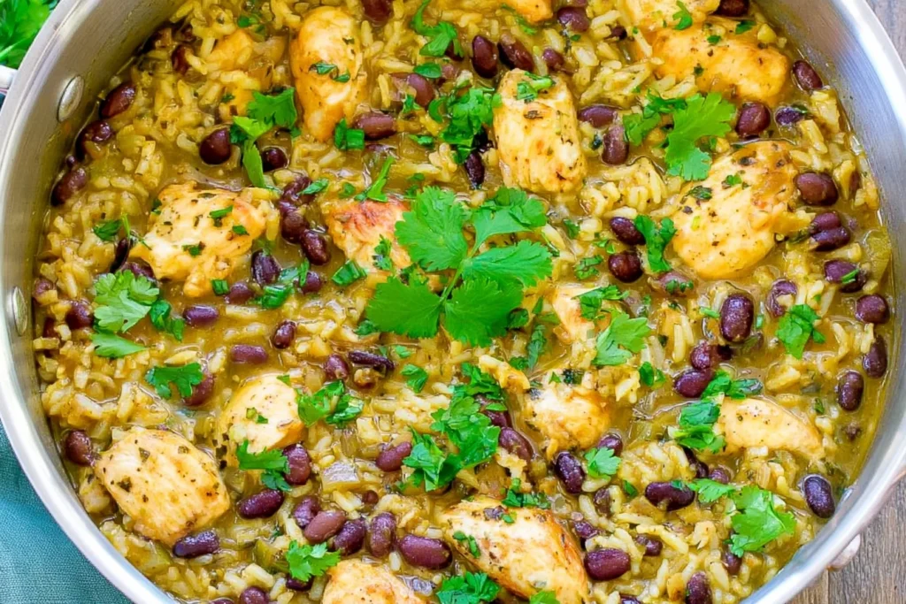 Salsa Verde Chicken Rice and Beans with tender chicken, black beans, fluffy rice, and fresh cilantro in a skillet