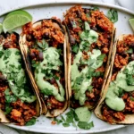 Black Bean Quinoa Tacos with creamy cilantro lime sauce, black beans, and quinoa in charred tortillas