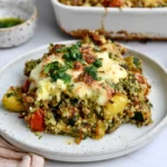 Quinoa Pesto Bake Dump & Bake served with melted mozzarella, pesto quinoa, cherry tomatoes, vegetables, and fresh herbs
