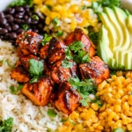 Chipotle Salmon Bowls with glazed salmon, avocado slices, black beans, corn, and rice in a colorful healthy meal bowl