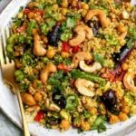 Curry Cashew Chickpea Quinoa Salad with toasted cashews, chickpeas, quinoa, red peppers, green vegetables, and fresh cilantro.