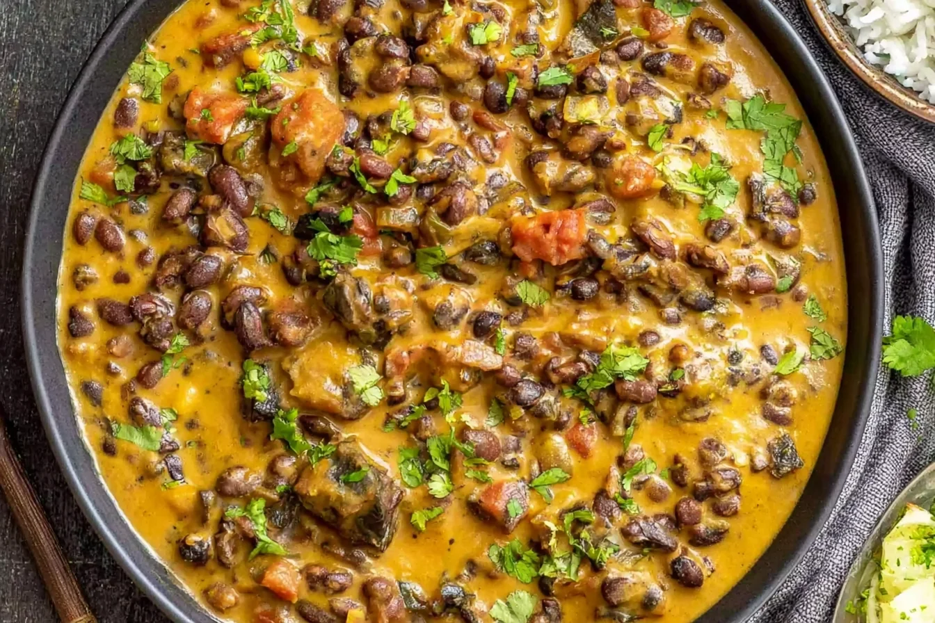 Creamy Black Bean Curry with tender black beans, tomatoes, warm spices, and fresh cilantro in a rich golden coconut sauce.