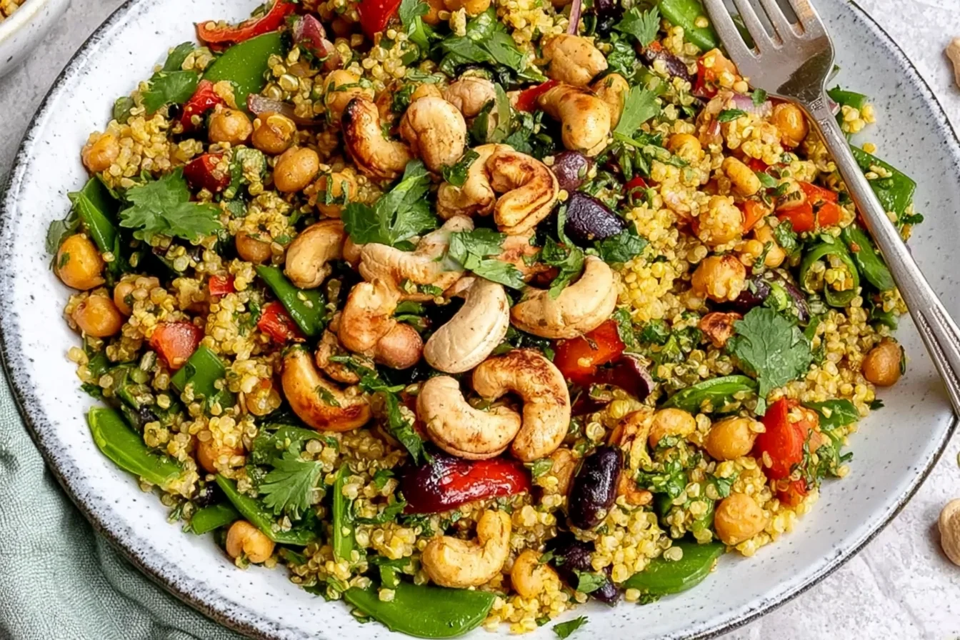 Curry Cashew Chickpea Quinoa Salad with toasted cashews, chickpeas, colorful vegetables, quinoa, and fresh herbs.