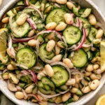 Dilly White Bean Cucumber Salad with creamy white beans, crisp cucumbers, red onion, fresh dill, and lemon vinaigrette in a serving bowl.