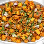 Lentil Sweet Potato Salad with roasted sweet potatoes, tender lentils, fresh parsley, and onions in a white serving dish.