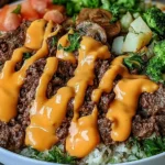 Smash Burger Bowl with seasoned ground beef, roasted vegetables, cauliflower rice, broccoli, mushrooms, and creamy burger sauce.
