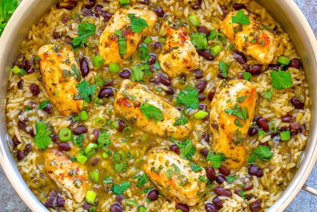 Salsa Verde Chicken Rice and Beans with golden chicken breast, black beans, seasoned rice, cilantro, and green onions in a skillet