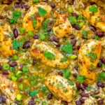 Salsa Verde Chicken Rice and Beans with golden chicken breast, black beans, seasoned rice, cilantro, and green onions in a skillet