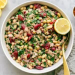 Tuna And White Bean Salad with cannellini beans, flaky tuna, parsley, red onion, sun-dried tomatoes, and fresh lemon.
