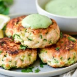 Chicken Zucchini Poppers topped with creamy cilantro sauce and served with fresh lemon wedges and herbs.
