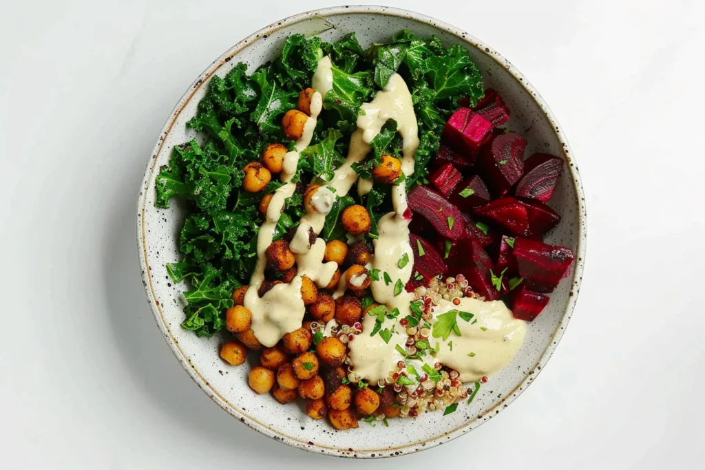 Quinoa Beet Bowls with kale, roasted chickpeas, and creamy tahini dressing in a healthy vibrant bowl