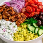 High-Protein Chicken Gyro Bowls with seasoned chicken, cucumber, tomatoes, red onion, olives, rice, and creamy tzatziki.