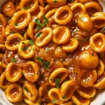 One Pot French Onion Pasta with orecchiette, caramelized onions, savory sauce, fresh parsley, and cracked black pepper.