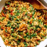 Thai Chicken Cabbage Stir Fry with chicken, shredded cabbage, carrots, green onions, cilantro, and savory peanut sauce.