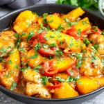 Thai Peach Chicken with juicy chicken, sweet peaches, red chili slices, and fresh herbs in a glossy savory sauce