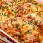 Baked Ricotta Chicken with marinara sauce, creamy ricotta, golden melted mozzarella, and fresh chopped herbs in a casserole dish