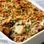 Chicken Wild Rice Casserole with tender chicken, wild rice, mushrooms, vegetables, creamy sauce, and a golden breadcrumb topping.
