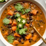 Chipotle Black Bean & Sweet Potato Soup with tender sweet potato, black beans, fresh cilantro, and sliced jalapeño.