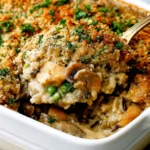 Chicken Wild Rice Casserole with tender chicken, wild rice, mushrooms, creamy sauce, crispy breadcrumbs, and fresh parsley.