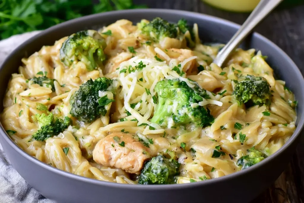 One Pot Broccoli Cheese Orzo with creamy cheddar sauce, tender broccoli, Parmesan, and fresh herbs in a bowl