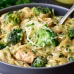 One Pot Broccoli Cheese Orzo with creamy cheddar sauce, tender broccoli, Parmesan, and fresh herbs in a bowl