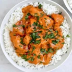 Pumpkin Chicken Curry with tender chicken in creamy pumpkin coconut sauce, served over white rice and topped with fresh cilantro.
