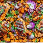 Chili Brown Sugar Chicken and Sweet Potatoes with glazed chicken breasts, roasted sweet potato cubes, red onions, and fresh herbs.