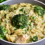 One Pot Broccoli Cheese Orzo with tender broccoli, creamy cheese sauce, Parmesan, and fresh herbs in a bowl