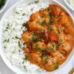 Pumpkin Chicken Curry with creamy pumpkin coconut sauce, tender chicken, white rice, red peppers, and fresh cilantro.