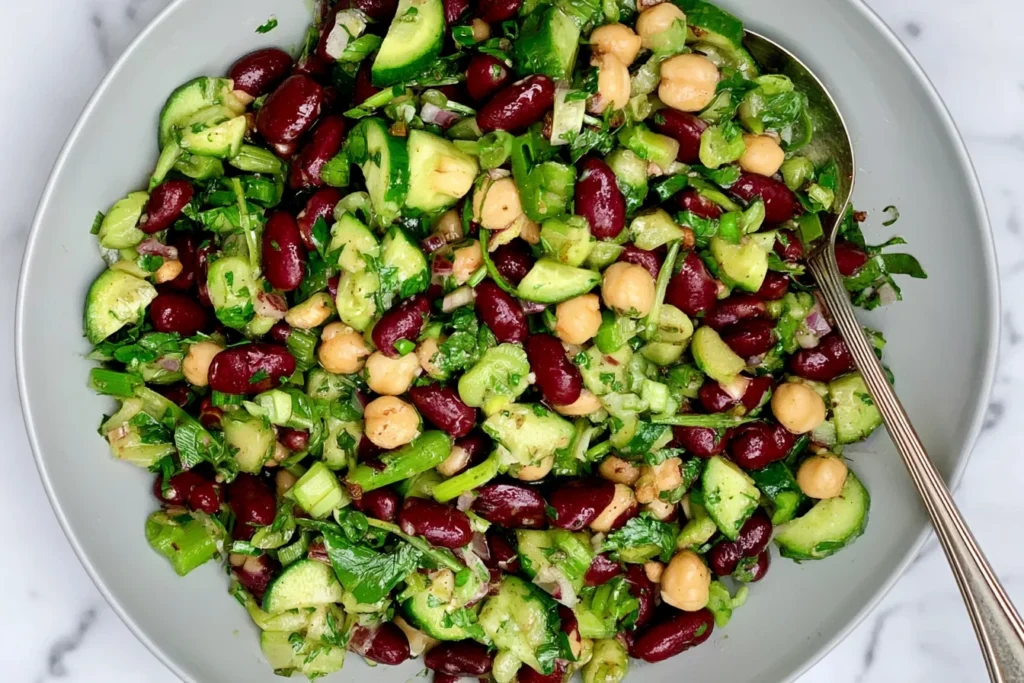 Simple Kidney Bean Salad with kidney beans, chickpeas, crisp cucumber, green onions, and fresh herbs tossed in a zesty dressing.