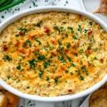 Maryland Crab Dip baked with lump crab, golden melted cheese, fresh parsley, and toasted bread for dipping