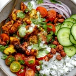 Cauliflower Shawarma Bowls with roasted spiced cauliflower, chickpeas, basmati rice, cucumber, tomatoes, red onion, and green tahini sauce