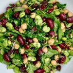 Simple Kidney Bean Salad with kidney beans, chickpeas, fresh greens, herbs, and a light homemade dressing in a white bowl.