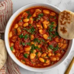 Moroccan Stewed White Beans- Loubia in a rich tomato and herb sauce, served with warm pita bread.
