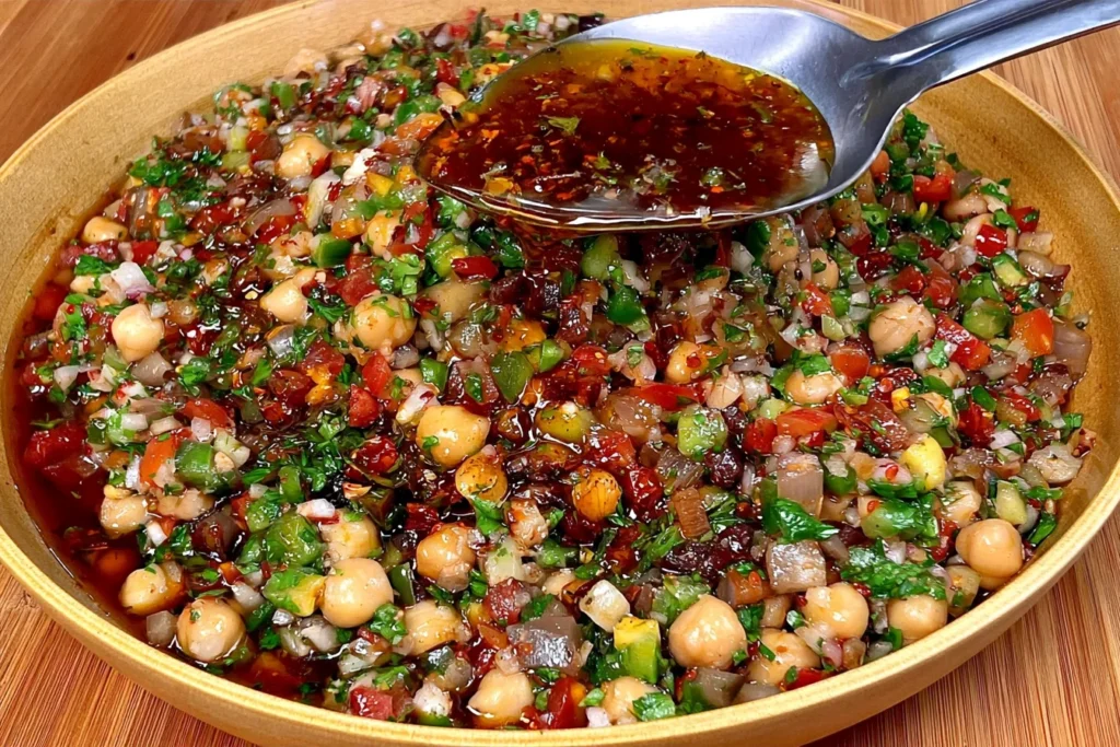 Balela Salad (Lebanese Chickpea Salad) with chickpeas, diced tomatoes, cucumber, red onion, fresh parsley, and rich pomegranate dressing.
