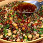 Balela Salad (Lebanese Chickpea Salad) with chickpeas, diced tomatoes, cucumber, red onion, fresh parsley, and rich pomegranate dressing.