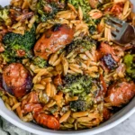 Chicken Sausage Broccoli and Orzo Skillet served in a white bowl with golden-browned chicken sausage slices, tender broccoli, and savory orzo pasta.