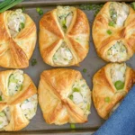 Cream Cheese Chicken Croissants filled with creamy shredded chicken and green onions, baked until golden and flaky on a sheet pan.