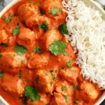 Crockpot Chicken Tikka Masala with tender chicken in creamy tomato sauce, served with basmati rice and fresh cilantro.