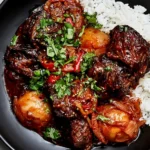 Korean Style Pot Roast with tender beef chunks in a rich gochujang sauce, served with fluffy white rice, caramelized onions, and fresh cilantro.