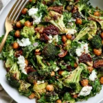 Roasted Broccoli and Chickpea Salad with charred broccoli, crispy chickpeas, creamy feta, fresh herbs, dates, and red onion.